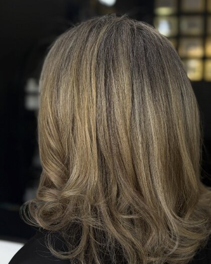 Client with a blonde balayage lob, seen from behind